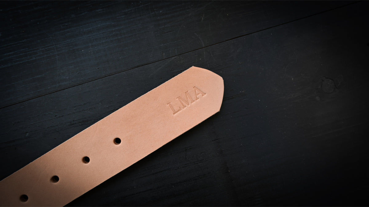 Natural belt  personalized with embossed initials, shown as L M A.