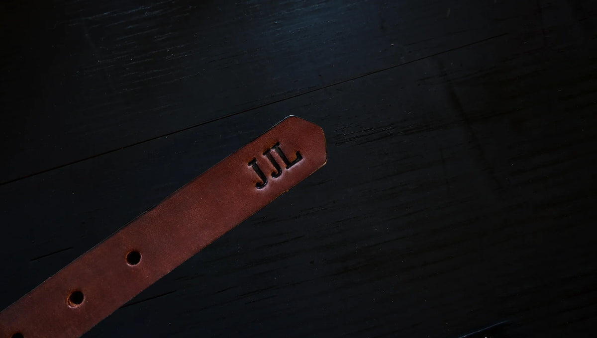 dress belt personalized with embossed initials, shown as J J L.
